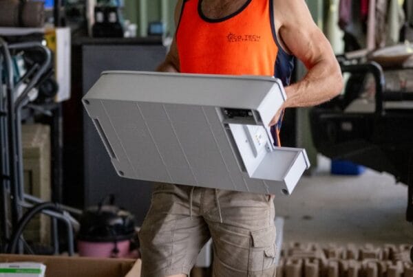 Eco Tech Electrical team member carrying installation materials for a solar project in Darwin, NT