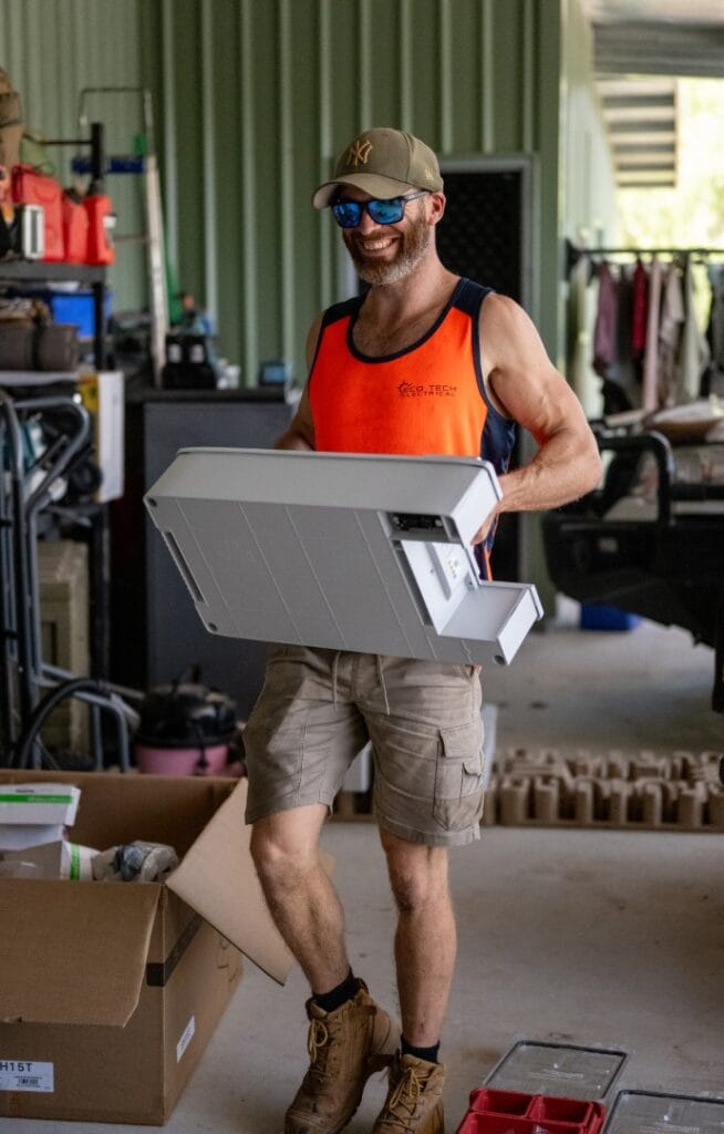 Eco Tech Electrical team member carrying installation materials for a solar project in Darwin, NT