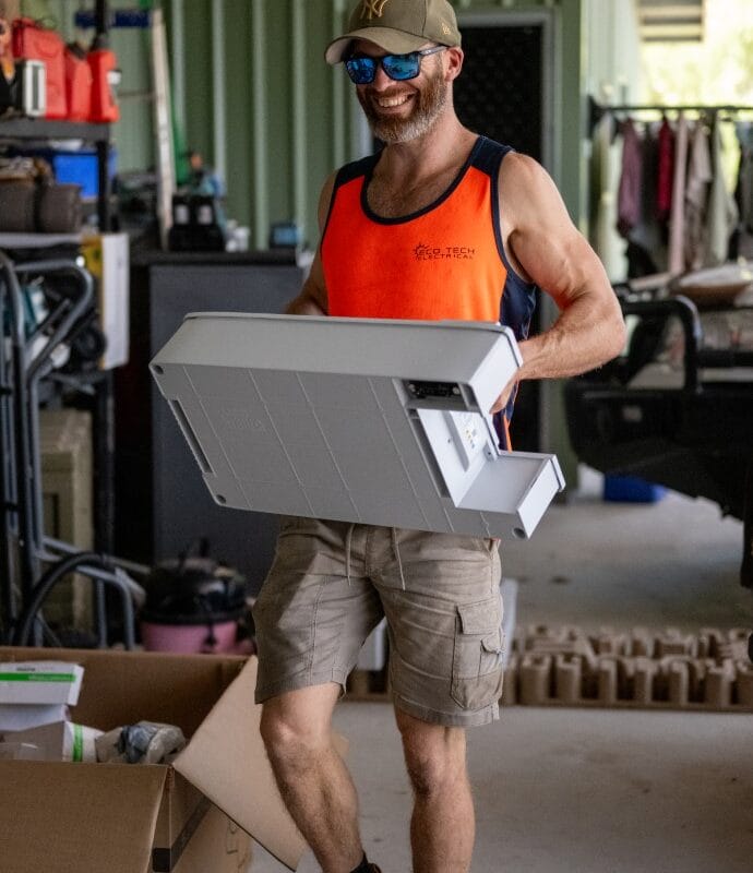 Eco Tech Electrical team member carrying installation materials for a solar project in Darwin, NT