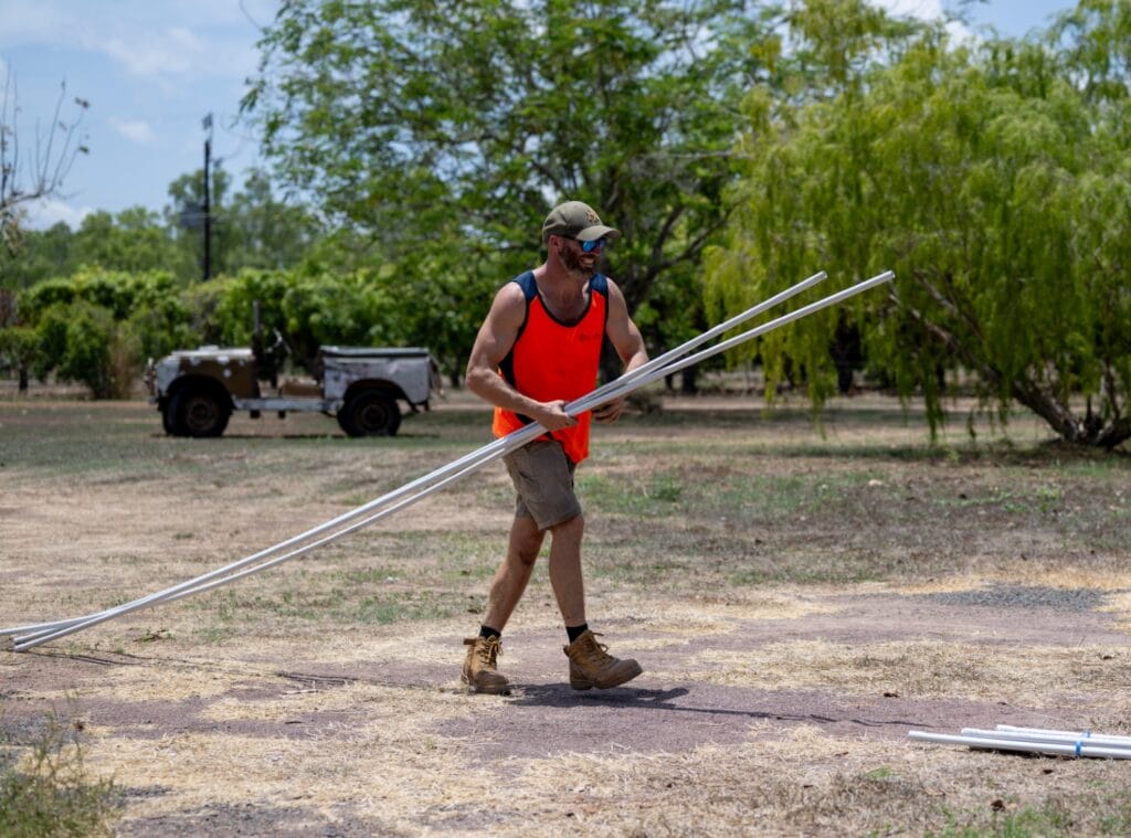 Eco Tech Solar Eco Tech Electrical team member carrying installation materials for a solar project in Darwin, NT